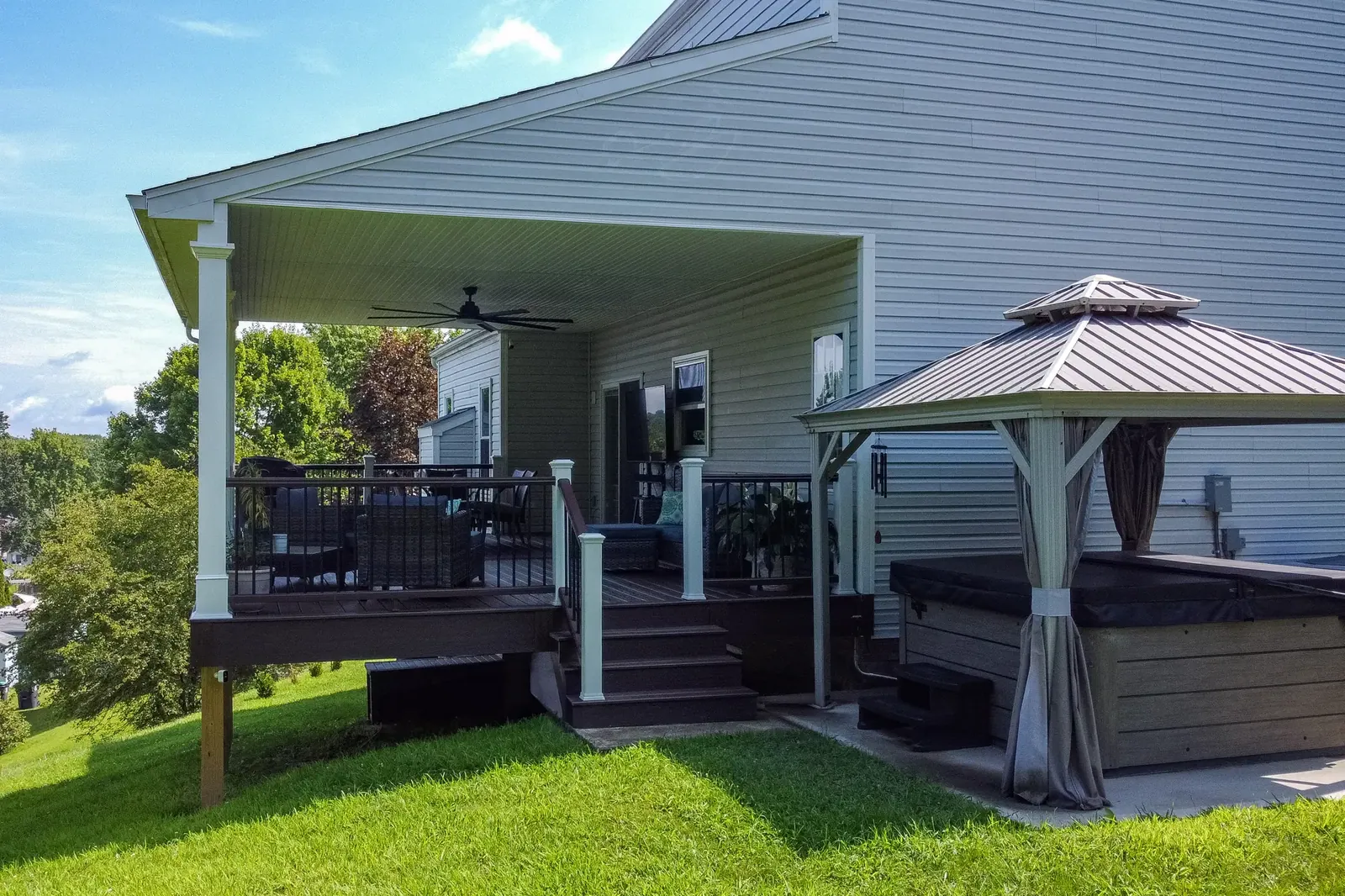 Covered deck & hot tub built by Oasis Custom Decks