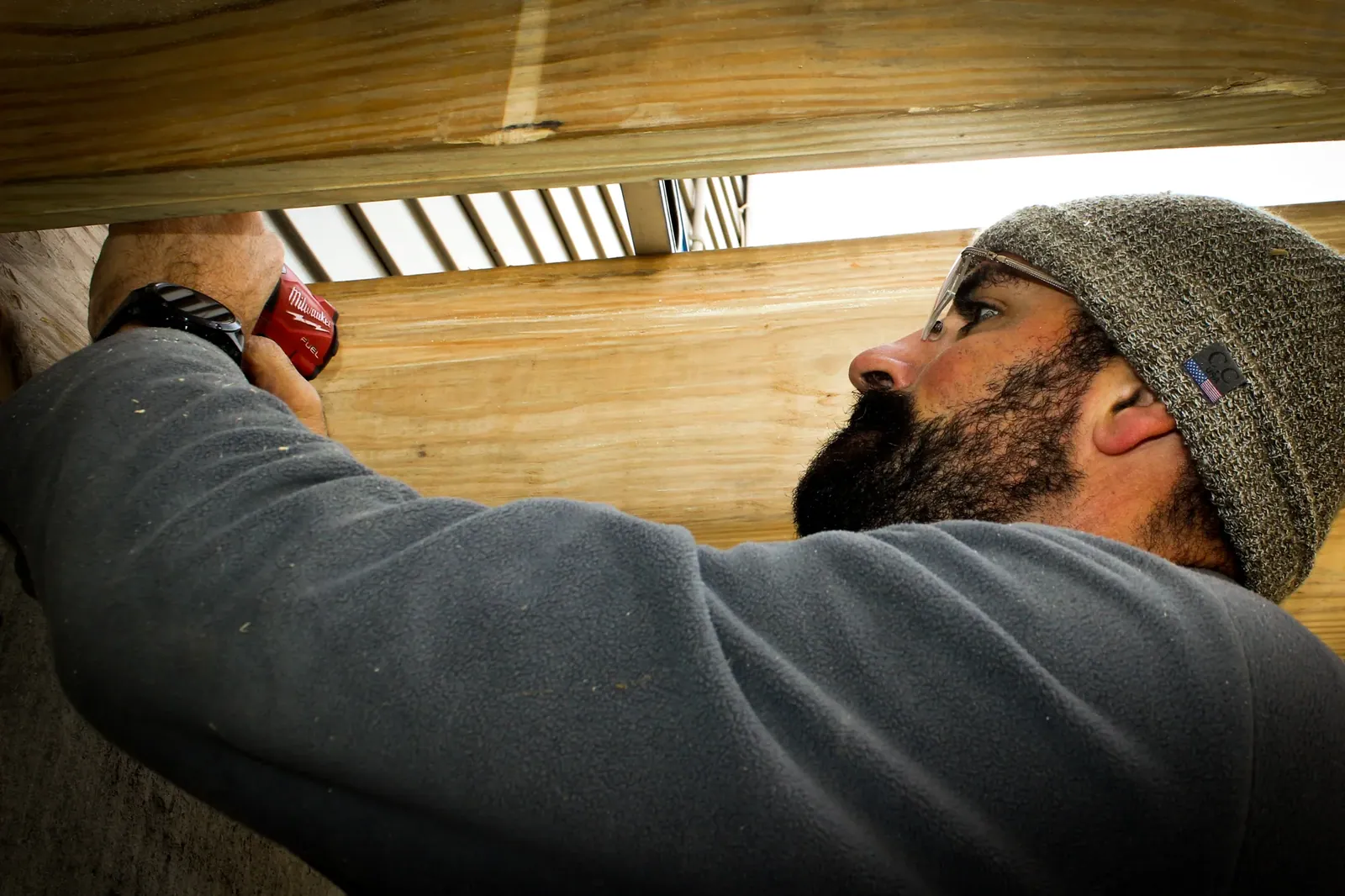 Jacob Weaver, owner of Oasis Custom Decks, installing an under-deck ceiling
