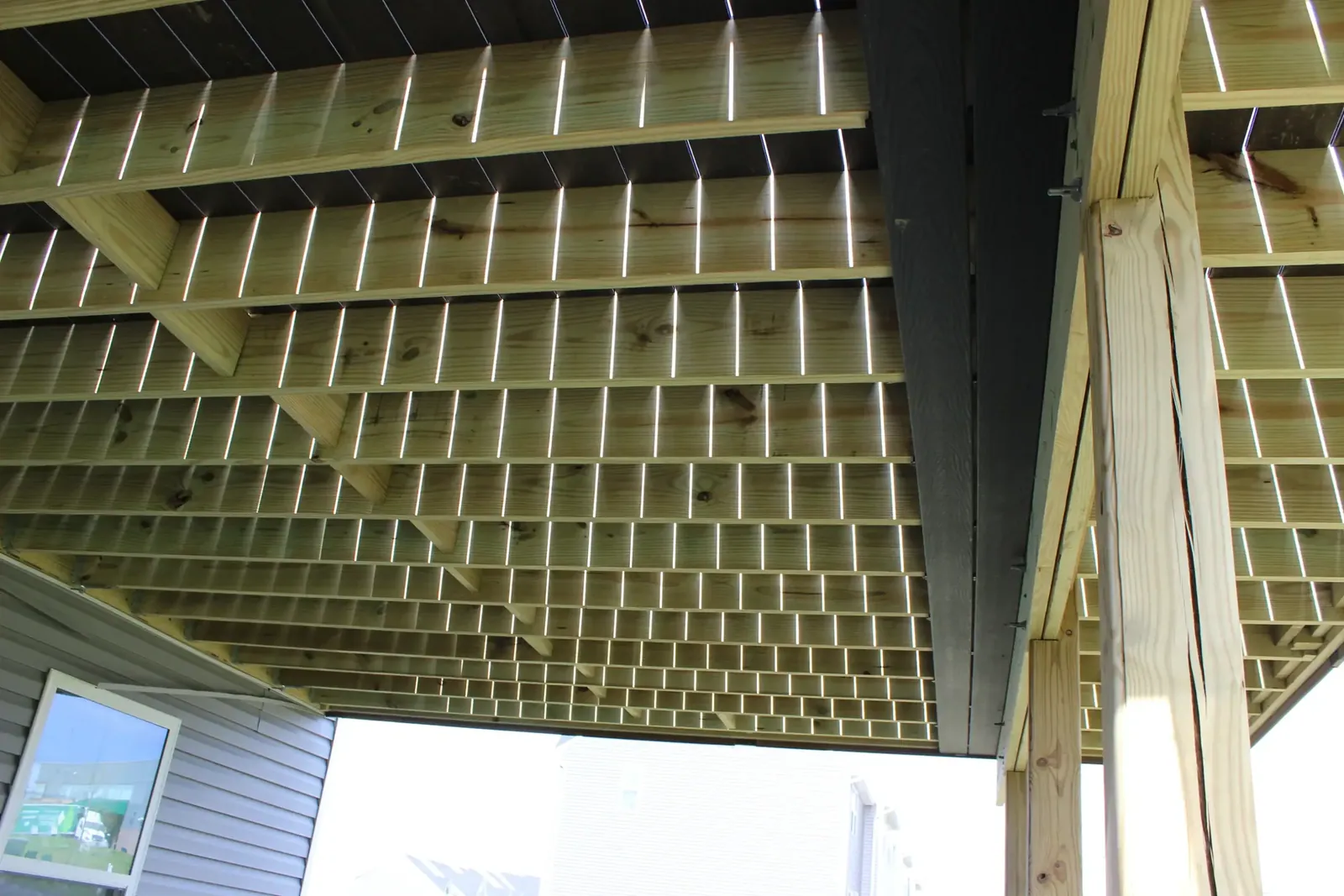 Trex RainEscape under-deck drainage system installed above the joists