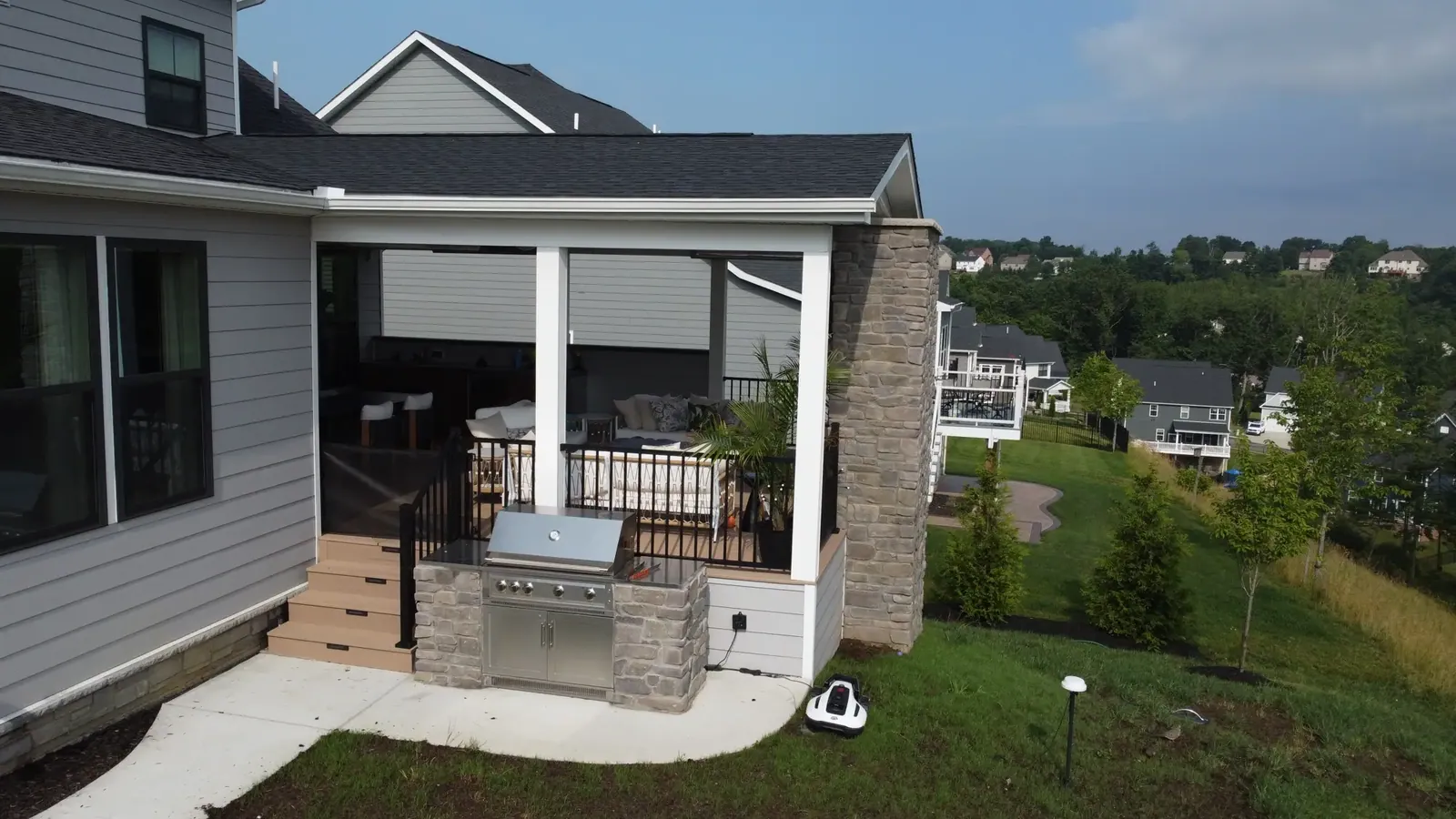 Outdoor kitchen & covered porch built by Oasis Custom Decks